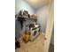 Functional laundry room featuring a modern washer and dryer, storage shelves, and tile flooring at 1029 Dampierre Ct, Kissimmee, FL 34759
