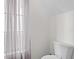 Cozy bathroom featuring a toilet and window with sheer curtains allowing for natural light at 1047 Banks Rose St, Kissimmee, FL 34747