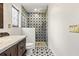 Bathroom featuring walk-in shower, unique tile design, and bright fixtures creating a luxurious experience at 1047 Banks Rose St, Kissimmee, FL 34747