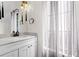 Well-lit bathroom featuring marble countertops, a sink, and decorative lighting at 1047 Banks Rose St, Kissimmee, FL 34747