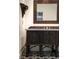 Unique bathroom featuring a carved wood vanity with starburst detailing and decorative mirror at 1047 Banks Rose St, Kissimmee, FL 34747