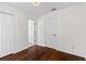 This bedroom has hardwood floors and three doors with white paint at 1047 Banks Rose St, Kissimmee, FL 34747