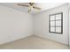 This bedroom is empty with a ceiling fan and a window with blinds at 1047 Banks Rose St, Kissimmee, FL 34747