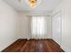 Bedroom featuring wood floors, natural light from the window, and closet for storage at 1047 Banks Rose St, Kissimmee, FL 34747