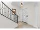 Elegant foyer with tile floors, a staircase with iron railings, and a stained glass window at 1047 Banks Rose St, Kissimmee, FL 34747
