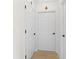 Hallway with tiled floor and white paneled doors, creating a clean and bright passage at 1047 Banks Rose St, Kissimmee, FL 34747