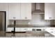 Bright kitchen with granite countertops, white cabinets, and stainless steel appliances at 1047 Banks Rose St, Kissimmee, FL 34747