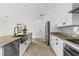 Spacious kitchen features white cabinets, granite counters, and an island with seating and a bronze sink at 1047 Banks Rose St, Kissimmee, FL 34747