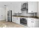 Well-equipped kitchen with stainless steel appliances, granite countertops, and white cabinets at 1047 Banks Rose St, Kissimmee, FL 34747
