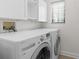 Well-lit laundry room with washer, dryer, cabinetry, and window for a functional space at 1047 Banks Rose St, Kissimmee, FL 34747