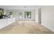 Open-concept living area with tile flooring, white walls, and a door leading to the backyard at 1047 Banks Rose St, Kissimmee, FL 34747