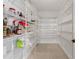Spacious pantry with wire shelving and tiled floor, maximizing storage and organization at 1047 Banks Rose St, Kissimmee, FL 34747