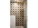 Stylish tiled shower with elegant brass fixtures and starburst patterned tile design at 1047 Banks Rose St, Kissimmee, FL 34747