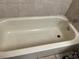Close-up of bathtub with tiled surround and shower head at 108 Creekside Way, Orlando, FL 32824
