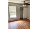 Bedroom with laminate wood flooring, window, and closet with sliding doors for ample storage at 108 Creekside Way, Orlando, FL 32824