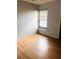 Cozy bedroom with laminate wood flooring and a window that lets in natural light at 108 Creekside Way, Orlando, FL 32824