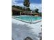 Community pool with clear blue water, palm trees and lounge chairs for relaxing in the sun at 108 Creekside Way, Orlando, FL 32824
