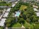Aerial showcasing the neighborhood amenities featuring pool, clubhouse, green spaces, and lush landscaping at 1211 Celebration Ave # 102, Celebration, FL 34747