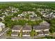 Overhead view of townhome community displaying the architectural design, landscaping, and street layout at 1211 Celebration Ave # 102, Celebration, FL 34747