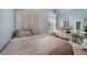 Comfortable bedroom with soft blue walls, plush bedding, a window for natural light, and ample storage space at 1211 Celebration Ave # 102, Celebration, FL 34747