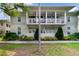 Charming two-story home with a beautiful covered porch and manicured landscaping, creating a welcoming curb appeal at 1211 Celebration Ave # 102, Celebration, FL 34747