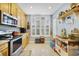 Well-designed kitchen with stainless steel appliances, light wood cabinets, and ample natural light at 1211 Celebration Ave # 102, Celebration, FL 34747