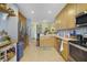 Open kitchen with stainless steel appliances, light wood cabinets, and decorative backsplash at 1211 Celebration Ave # 102, Celebration, FL 34747