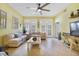 Bright living room with tile floors, large windows, and comfortable seating, ideal for entertaining guests at 1211 Celebration Ave # 102, Celebration, FL 34747