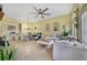 Spacious living room features tile floors, a ceiling fan, and neutral decor, creating a cozy atmosphere at 1211 Celebration Ave # 102, Celebration, FL 34747