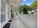 Inviting covered porch with a white rocking chair and French doors, perfect for relaxing and enjoying the outdoors at 1211 Celebration Ave # 102, Celebration, FL 34747