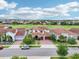 Community aerial view featuring Mediterranean-style homes, a golf course, and tree-lined streets at 13136 Alderley Drive Dr, Orlando, FL 32832