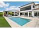 Resort-style backyard boasts a pool, spa, outdoor kitchen, and covered patio for entertaining at 13136 Alderley Drive Dr, Orlando, FL 32832