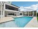 Stunning pool area with a hot tub, covered patio, spacious seating, and serene landscaping at 13136 Alderley Drive Dr, Orlando, FL 32832