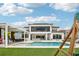 Luxury backyard featuring a pristine pool, outdoor kitchen, covered patio, and a charming play area at 13136 Alderley Drive Dr, Orlando, FL 32832