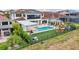 Large backyard features a private pool, patio, outdoor kitchen, playground, and solar panels on the home's red tile roof at 13136 Alderley Drive Dr, Orlando, FL 32832
