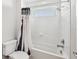 Clean bathroom features a shower/tub combo with white tile surround and a decorative shower curtain at 13136 Alderley Drive Dr, Orlando, FL 32832