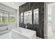 Modern bathroom featuring a sleek tub with dark wood accent wall and recessed shelving at 13136 Alderley Drive Dr, Orlando, FL 32832