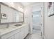 Bright bathroom featuring double sinks, white cabinets, and a tiled shower/bath combo at 13136 Alderley Drive Dr, Orlando, FL 32832