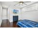 Well-lit bedroom features hard wood floors, a ceiling fan, and a mounted television for entertainment at 13136 Alderley Drive Dr, Orlando, FL 32832