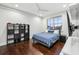 Bedroom with hardwood floors features a large window and a ceiling fan at 13136 Alderley Drive Dr, Orlando, FL 32832