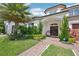 Inviting home entrance showcasing lush landscaping, a cozy seating area, and an elegant double door under a covered porch at 13136 Alderley Drive Dr, Orlando, FL 32832
