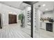 Entryway showcasing a modern wine cellar, adjacent bar area, and a view of the elegant front door at 13136 Alderley Drive Dr, Orlando, FL 32832