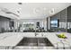 Spacious kitchen with a waterfall island, sink, and an open view of the living area and backyard at 13136 Alderley Drive Dr, Orlando, FL 32832