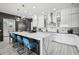Modern kitchen with waterfall island, bar seating, stainless steel appliances and a contemporary design at 13136 Alderley Drive Dr, Orlando, FL 32832