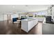 Spacious living area with an open floor plan featuring a modern kitchen, a bar, and lots of light at 13136 Alderley Drive Dr, Orlando, FL 32832
