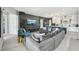 Open-concept living space featuring a modern kitchen, comfortable furniture, and a large screen TV for ultimate entertainment at 13136 Alderley Drive Dr, Orlando, FL 32832
