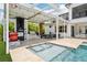 Outdoor kitchen with pizza oven, grill, and bar, plus a pool and hot tub at 13136 Alderley Drive Dr, Orlando, FL 32832
