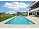 Spacious backyard with a large pool, outdoor kitchen, and covered patio seating at 13136 Alderley Drive Dr, Orlando, FL 32832