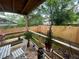 Cozy back porch with wood flooring, chairs and railing overlooking the backyard at 1407 Noble Pl, Orlando, FL 32801