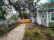 Backyard features a new fence, side deck, and a well-maintained yard at 1407 Noble Pl, Orlando, FL 32801